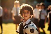 Brazilian young primary school student boy wearing uniform football portrait sunlight.
