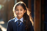 Peruvian young primary school student girl wearing uniform portrait standing smile.
