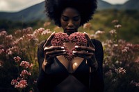 Black woman two hands making heart flower portrait plant.