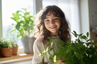 Girl holding plants smile portrait child. 
