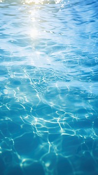 Ocean blue water surface with bright sun light reflections swimming backgrounds underwater.