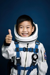 Asian boy wearing white astronaut suit protection happiness discovery.