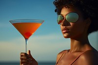African American woman cocktail sunglasses outdoors.