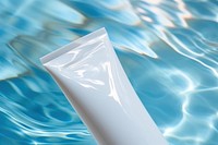  White cream tube toothpaste cosmetics swimming. AI generated Image by rawpixel.