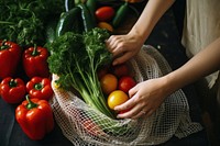 Taking organic vegetables out from net bag kitchen plant food. 