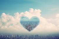Heart shaped clouds with the city background outdoors nature sky.