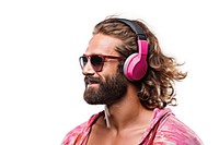 A man with bun hair headphones sunglasses listening.