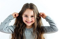Young girl tying her long hair child smile happy.