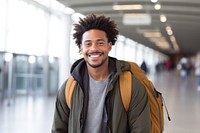African-American man carrying backpack smiling jacket adult.