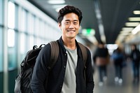Asian man carrying backpack smiling adult smile.