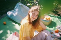 A teenage woman sitting picnic in the garden photography portrait outdoors. AI generated Image by rawpixel.