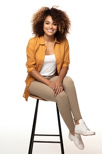 Smiling woman sitting on stool adult white background curly hair.