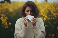 Young woman blowing her nose outdoors sweater adult. AI generated Image by rawpixel.