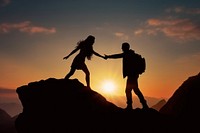 A man reaching his hand to grab a woman on the mountain silhouette sunset adult. 