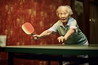 An elder woman playing pingpong sports adult relaxation.