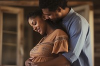 Mid adult couple expecting a baby while husband caresses the belly of his pregnant african woman touching portrait love.