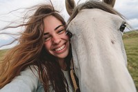 Horse and woman animal portrait smiling.