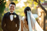 Groom crying happily seeing his beautiful bride walking towards him fashion wedding dress.
