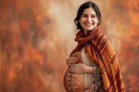 Pregnant woman smiling scarf smile.
