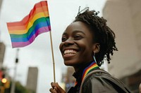 Black woman holding pride flag smiling smile architecture.