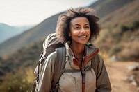 Middle-aged African American female backpacker mountain walking travel.