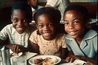 African American kids eating restaurant food cheerful.