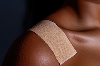 Adhesive medical bandage on black woman skin medicine shoulder football.