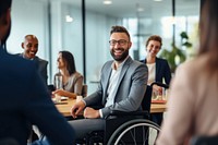 Man in a wheelchair in a business meeting smiling adult togetherness.
