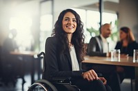 Woman in a wheelchair in a business meeting smiling adult smile.