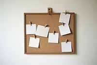Cork board with white polaroid cardboard paper frame.