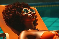 Black women sunglasses sunbathing portrait.