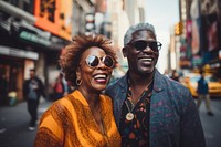 Middle-aged African couple photography sunglasses laughing.