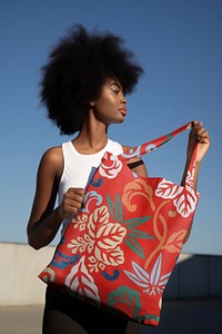 Woman holding floral red tote bag