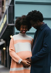 Black man holding hand pregnant woman street adult happy.