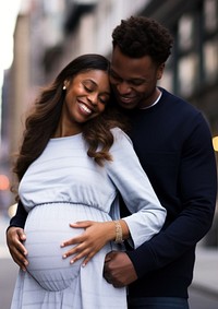 Black man holding hand pregnant woman portrait adult photo.