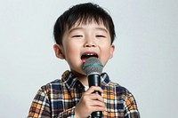 Little singer Japan boy microphone karaoke performance.