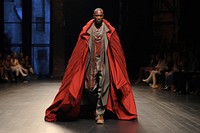 An african man model on fashion runway stage architecture performance.