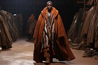 An african man model on fashion runway adult overcoat standing.