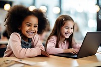 American girl kids sitting in font of laptop classroom computer child.