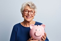 Woman holding his piggy bank glasses accessories retirement.