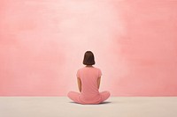 Woman wearing pink yoga outfit sitting adult contemplation.