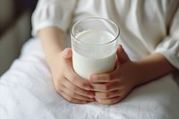 Kid hands in holding milk dairy drink glass. AI generated Image by rawpixel.
