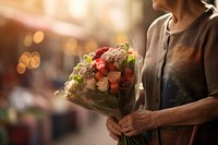 An older women holding bouquet flower adult illuminated.