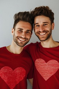 Couple gay man wearing heart-shaped matching shirts smiling adult love.