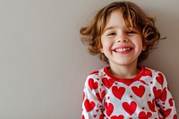 Kid wearing heart-shaped matching shirts portrait smiling smile.