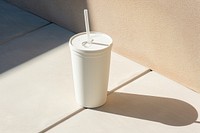 A blank white arter cold tumbler with straw  shadow milk refreshment.