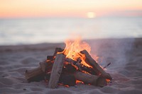 Campfire on the beach outdoors bonfire sunset. AI generated Image by rawpixel.