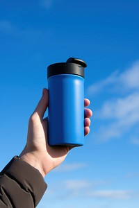 Holding hydro flask coffee mug with flex sip lid blue sky refreshment.