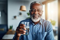 Black senior man drinking water at home refreshment relaxation retirement. AI generated Image by rawpixel.