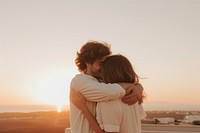 Celebrate their anniversary outdoors hugging sunset. 